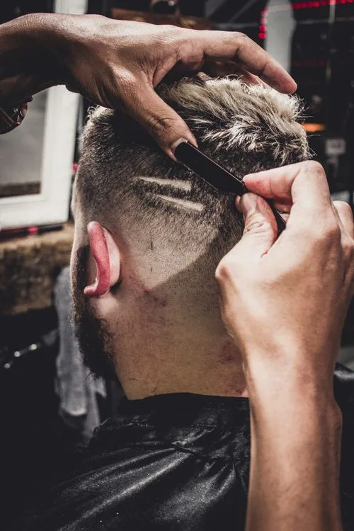 Man Having a Hair Cut Inside Shop